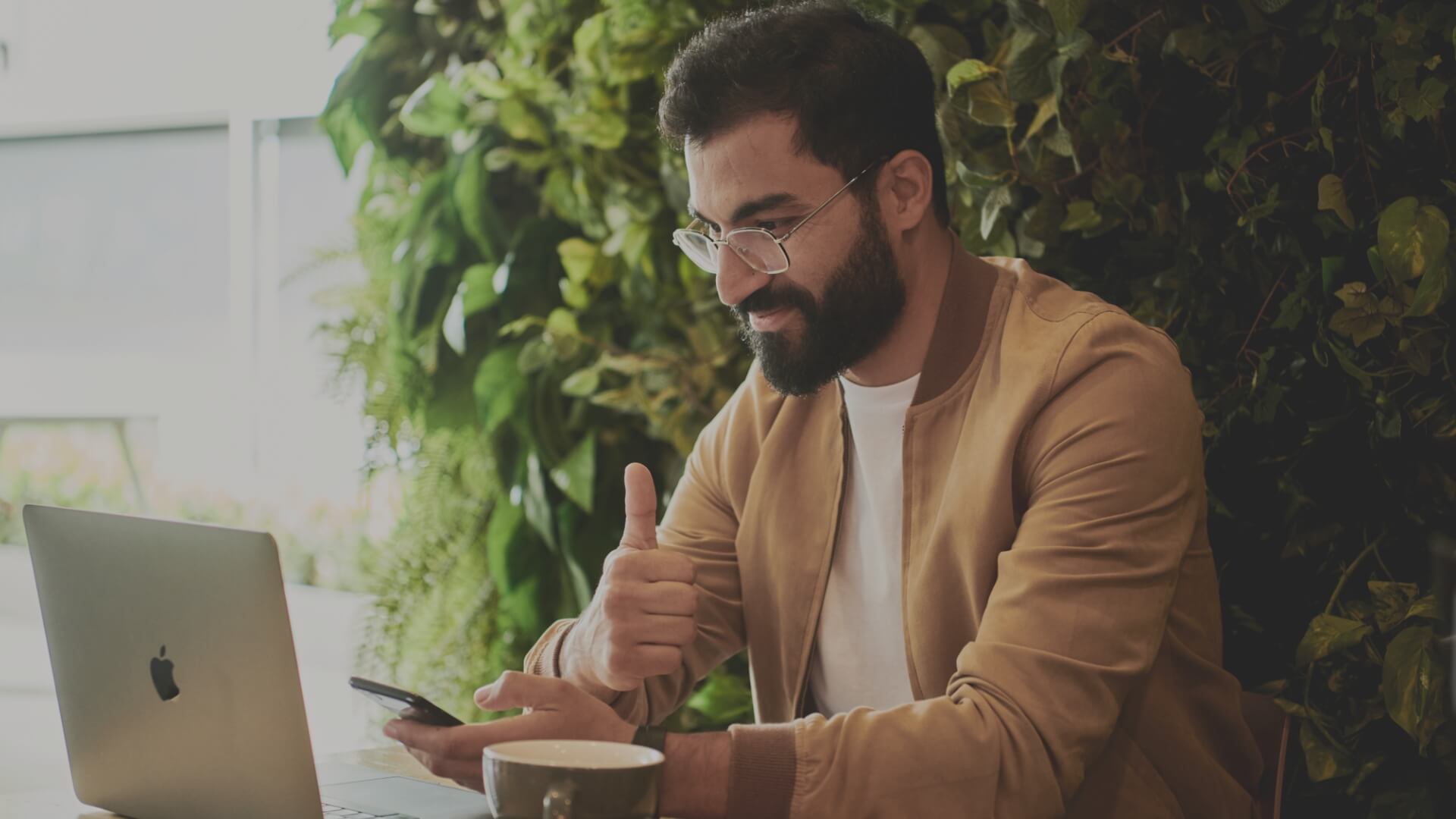 Home insurance specialist laughing and speaking on the phone and working on her laptop